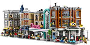 LEGO model of a city street with various buildings and characters.