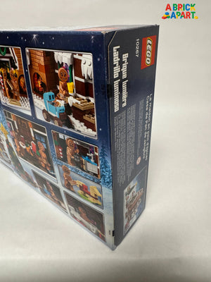 Back view of a LEGO set packaging with images and text on a light gray background.