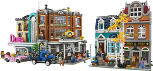 LEGO model of a small town with buildings and people on a white background