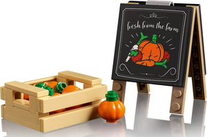 Toy crate with pumpkins and a small easel with a 'fresh from the farm' sign on a white background