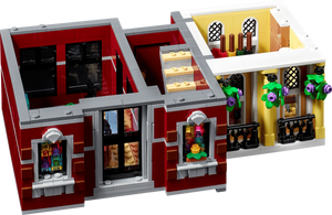 LEGO model of a two-story building with red and yellow facade