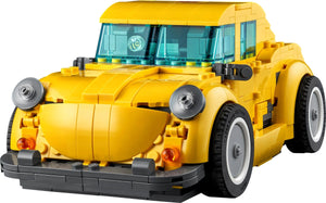 Yellow toy car made of interlocking bricks on a white background