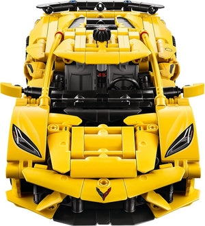 Yellow toy car with black accents on a white background