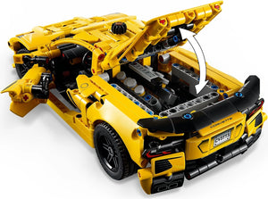 Yellow toy car model with open hood on a white background