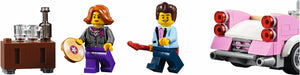 Two LEGO figures and a pink car with red lights on a white background