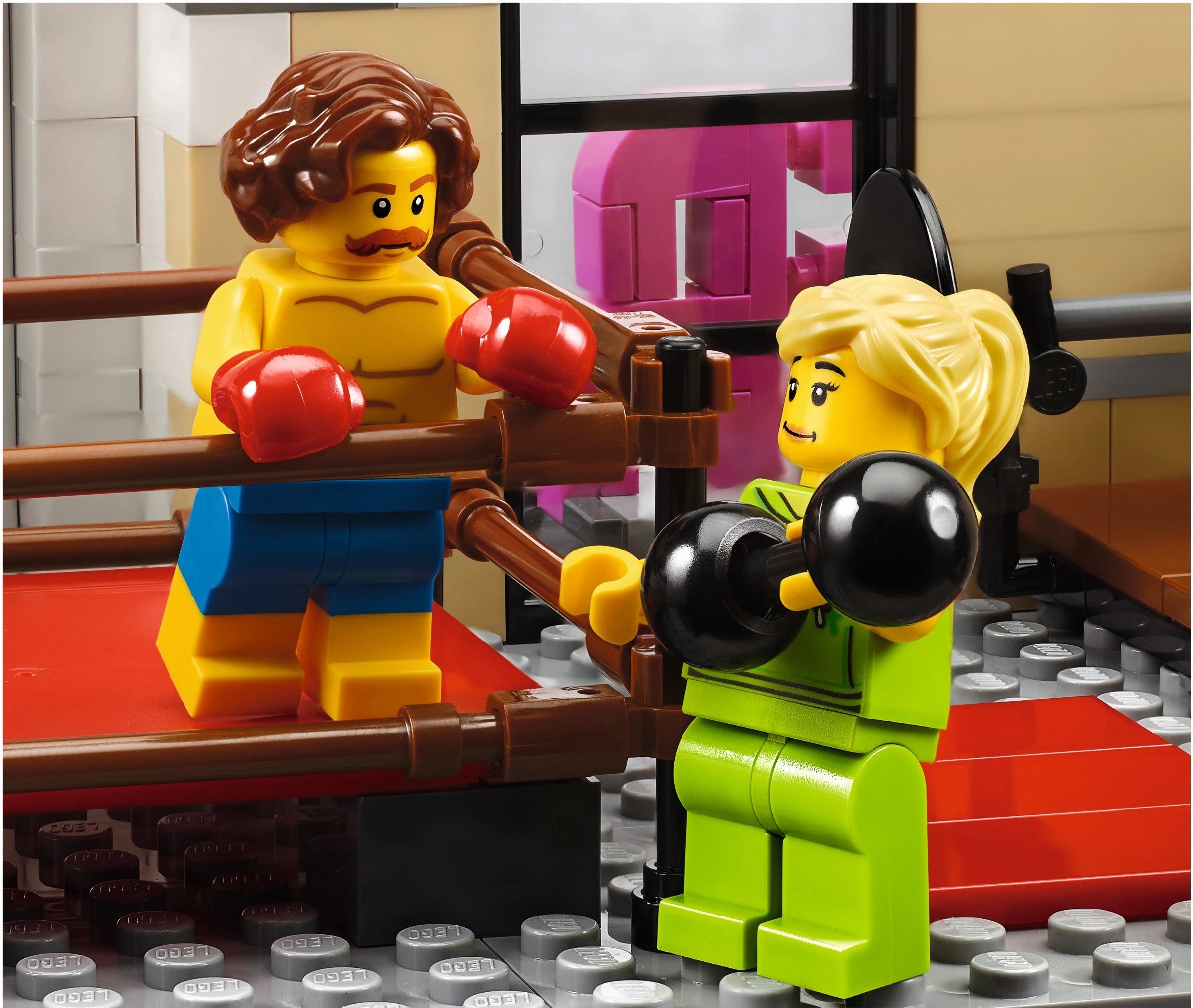 Two LEGO figures in a boxing match inside a LEGO ring.