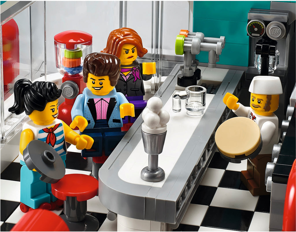 LEGO figures in a coffee shop setting with a barista and customers.