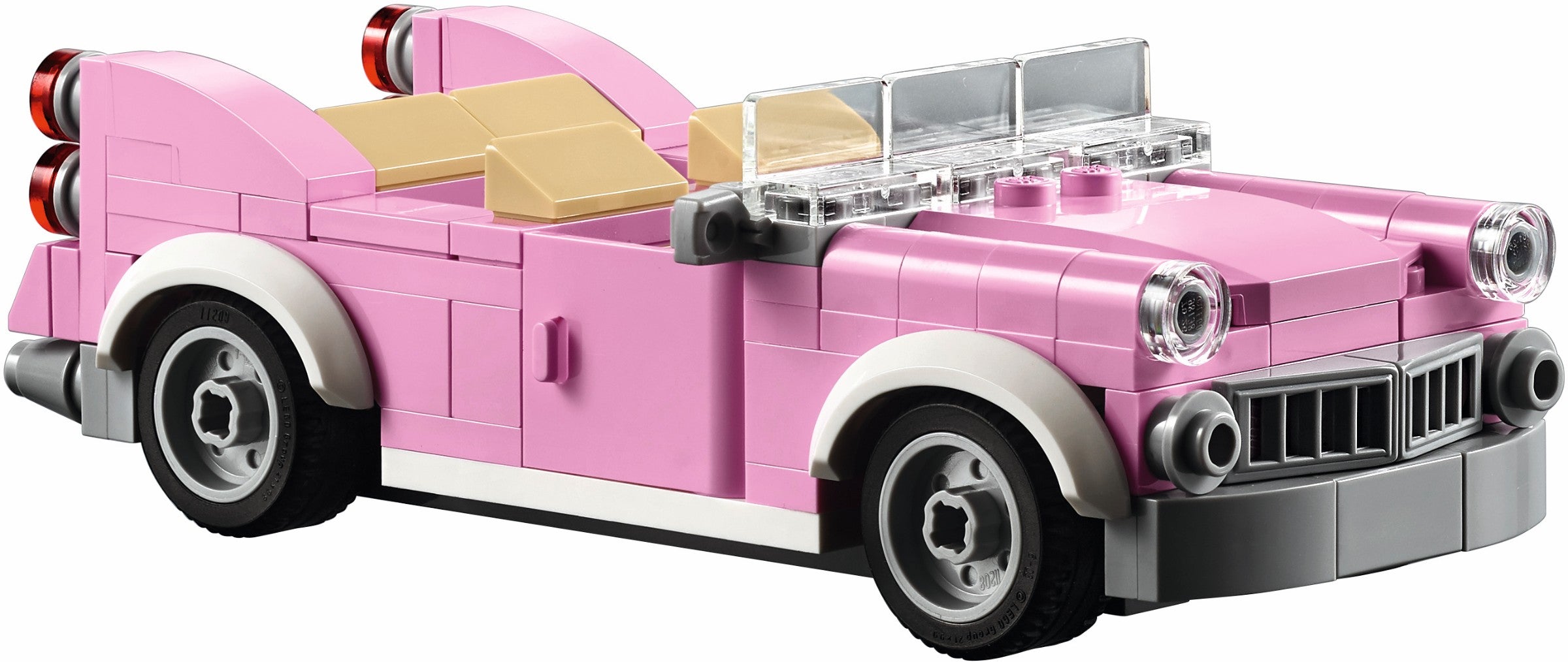 Pink vintage car model made of interlocking bricks on a white background