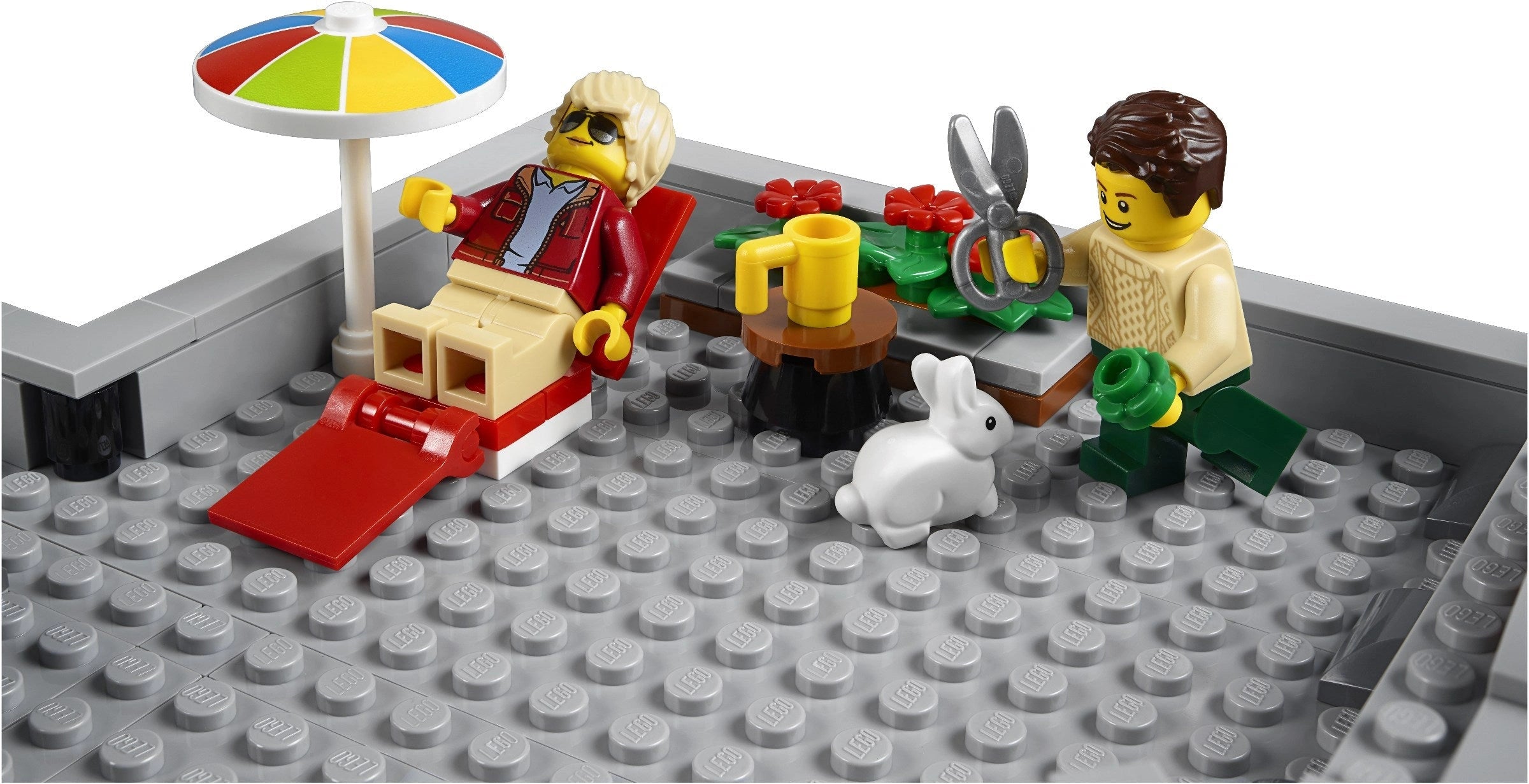 LEGO scene with two minifigures, a rabbit, and various items on a gray baseplate.