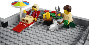 LEGO scene with two minifigures, a rabbit, and various items on a gray baseplate.