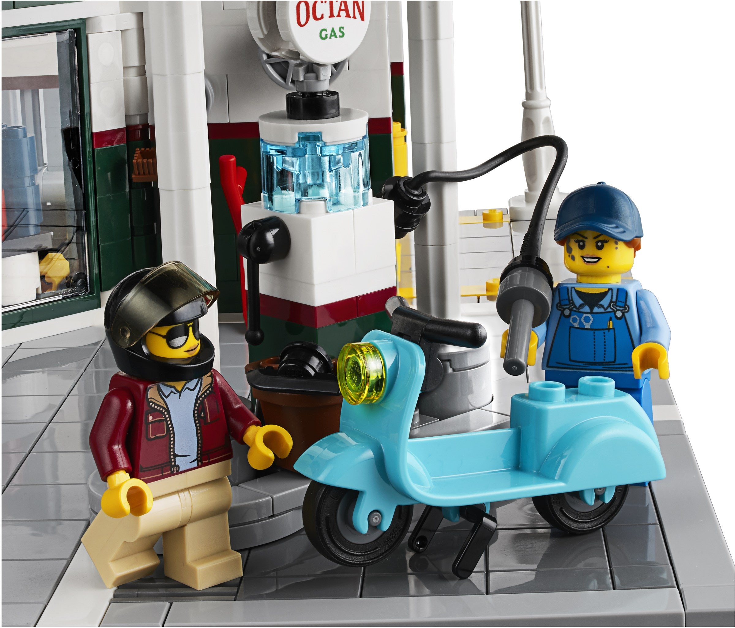 LEGO figures of a mechanic and a customer with a blue scooter in a garage setting.