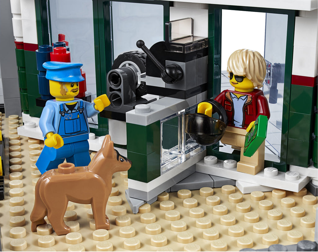 LEGO scene with two characters and a dog in front of a coffee machine.