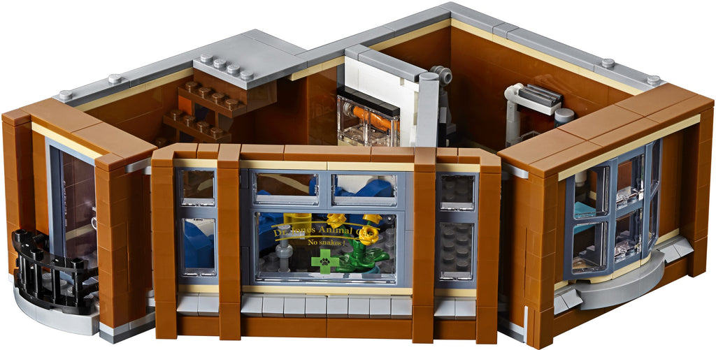 Detailed model of a building with multiple rooms and windows, resembling a LEGO set.