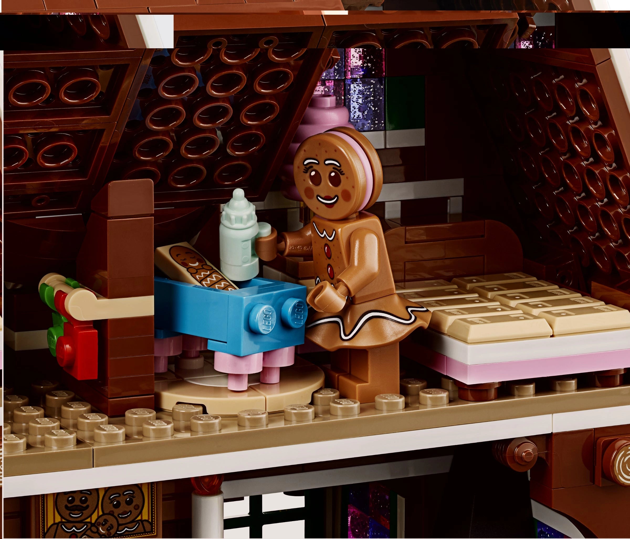 LEGO gingerbread man character with a bottle in a festive setting