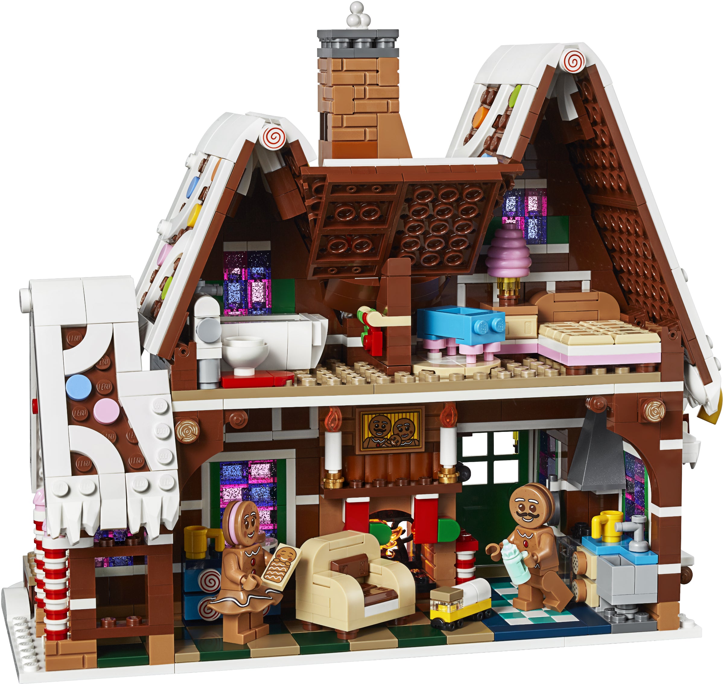 Toy gingerbread house with detailed interior and characters on a white background