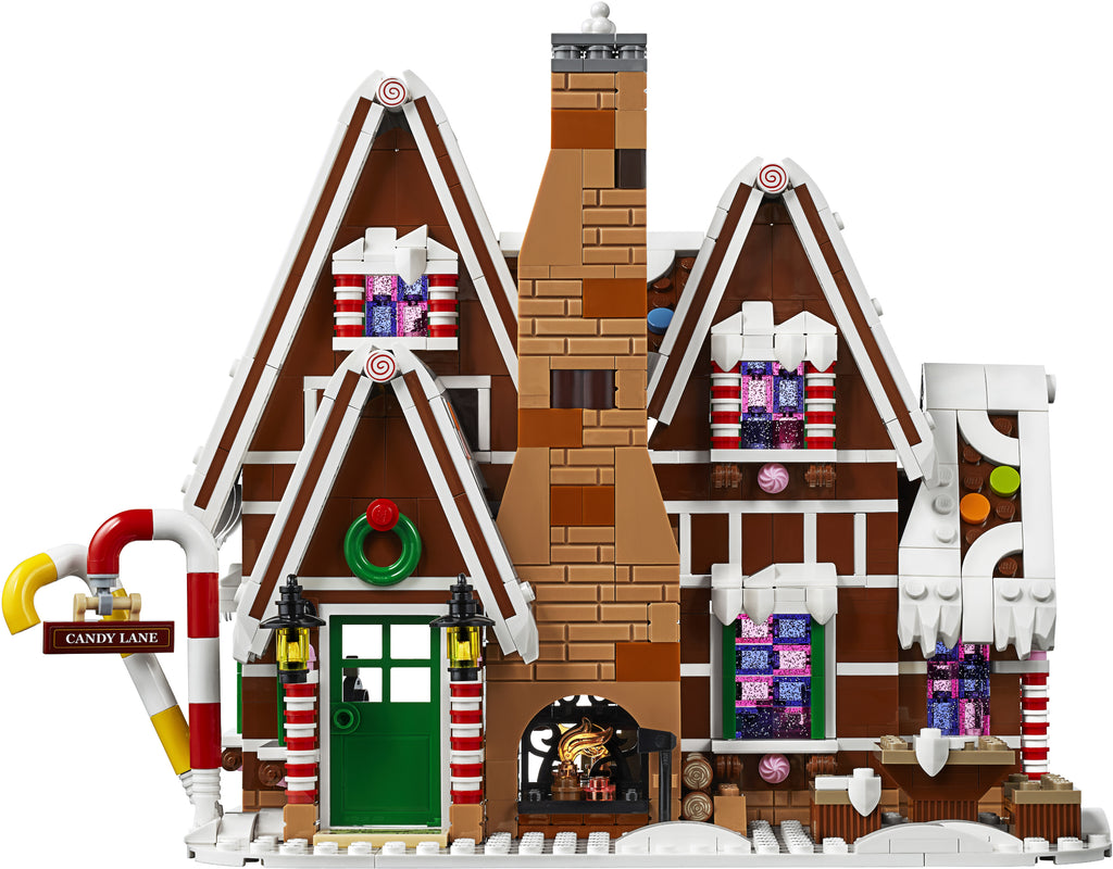 Toy gingerbread house with candy details on a white background