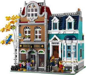 LEGO model of a bookstore with detailed architecture and characters on a white background