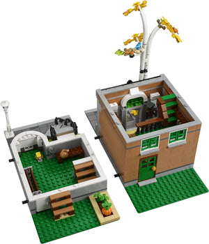 LEGO model of a small town street with buildings and streetlights on a white background