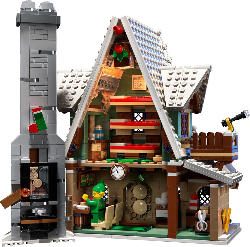 Toy house model with detailed interior and a character inside, on a white background