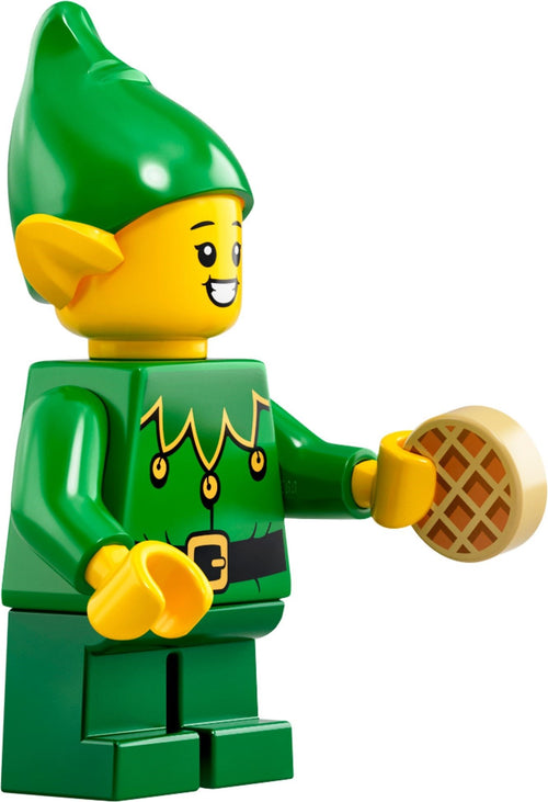 LEGO minifigure of a green elf holding a waffle on a white background