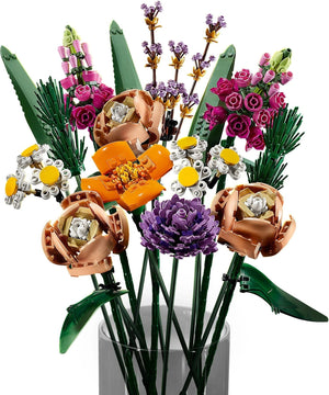 Colorful bouquet of flowers made from LEGO bricks in a clear vase on a white background