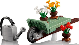 LEGO set with a watering can, table, and potted flowers on a white background