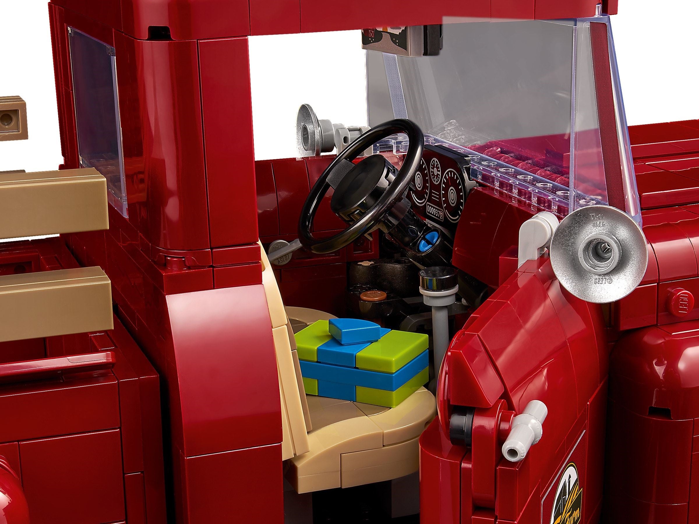 Close-up of a red toy truck with detailed interior and steering wheel.