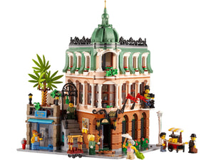 Detailed LEGO model of a building with green dome and people figures on a white background