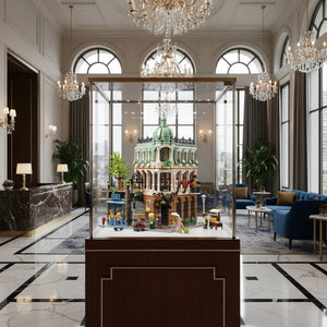 Display case with a miniature model of a building in a luxurious lobby.