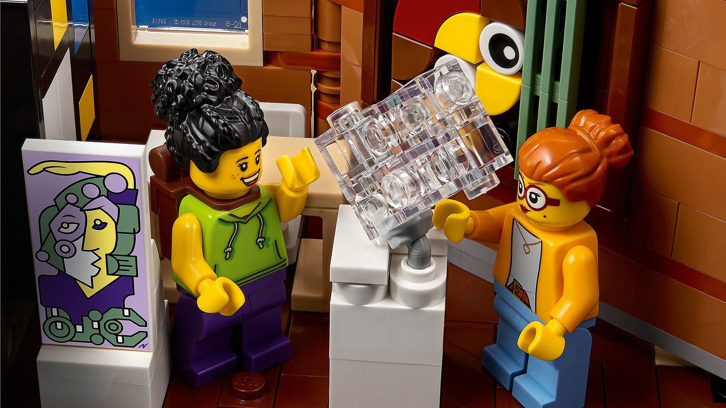 Two LEGO figures interacting with a transparent object in a room setting.