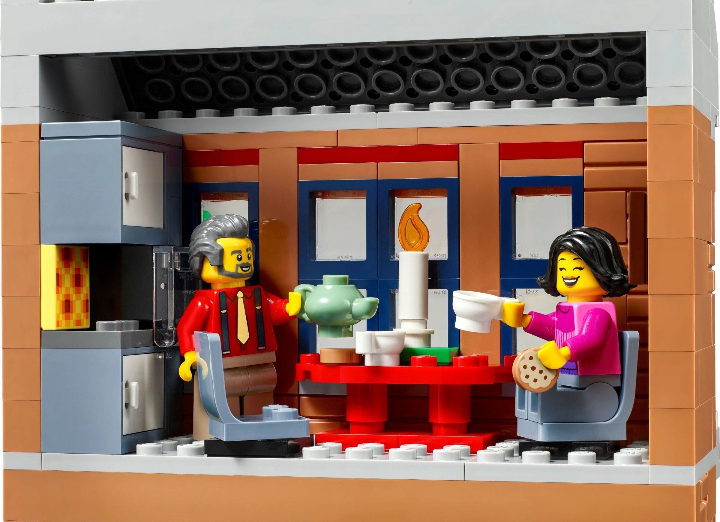 LEGO model of a cafe interior with two characters and various props.
