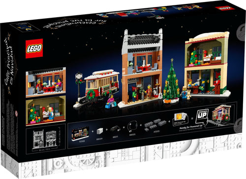 LEGO set packaging with Christmas-themed buildings and characters on a black background
