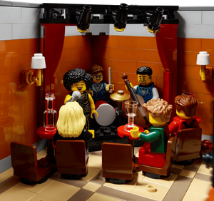 LEGO set with characters in a bar setting, complete with furniture and props.