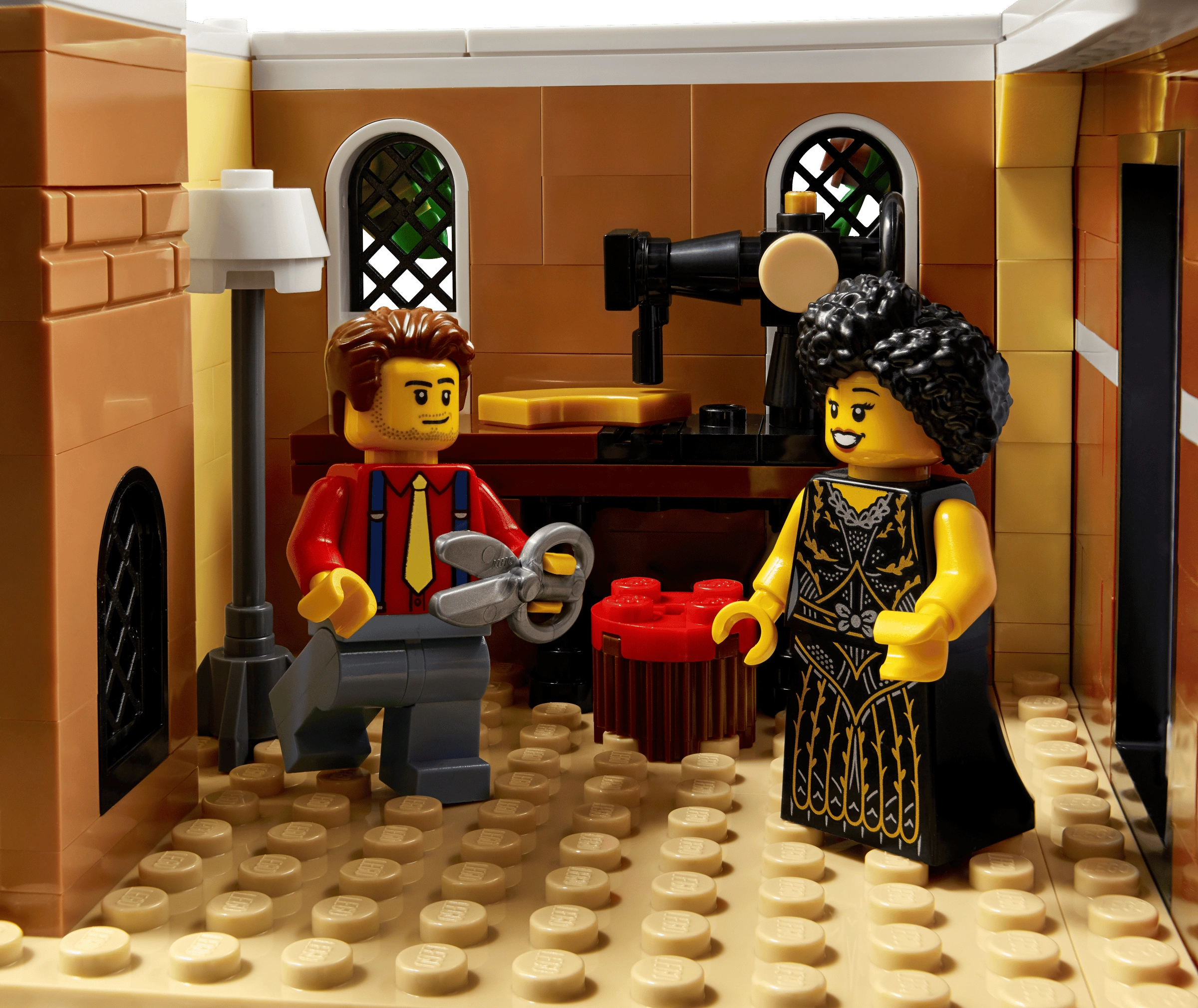 Two LEGO figures in a kitchen setting with a coffee machine and oven.