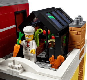 LEGO chef figure with a kitchen setup and a squirrel near a door.