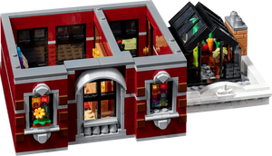 Toy building set with detailed interior and exterior, featuring a red facade and glass windows.