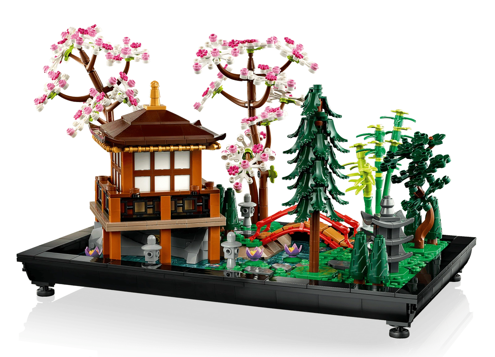 LEGO model of a Japanese-style building with cherry blossom trees and greenery on a white background