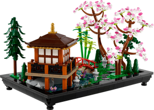 LEGO model of a Japanese-style building with cherry blossom tree and bridge on a transparent background
