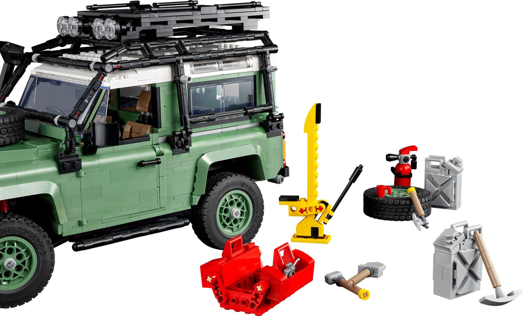 LEGO model of a green SUV with various accessories on a white background