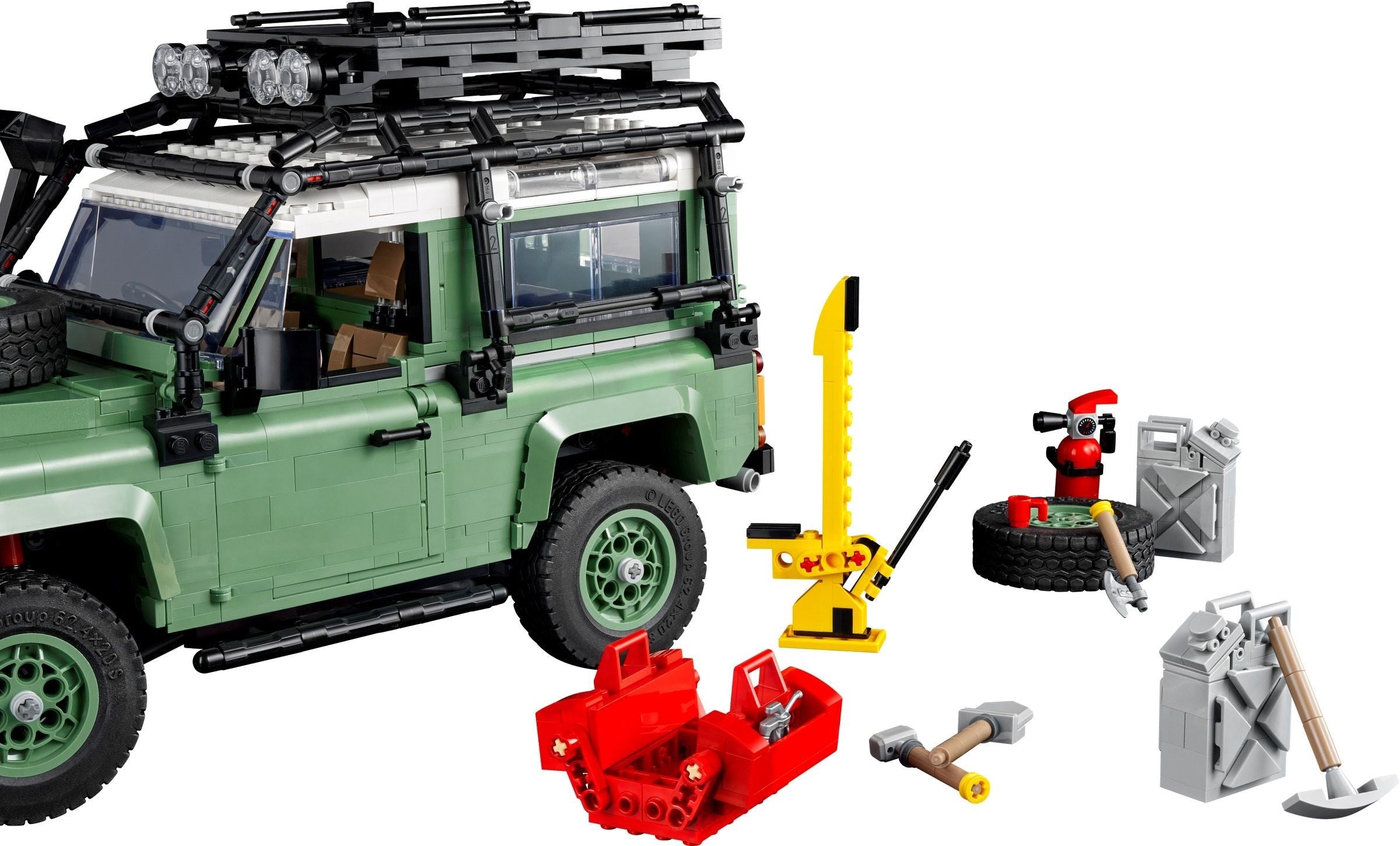 LEGO model of a green SUV with various accessories on a white background