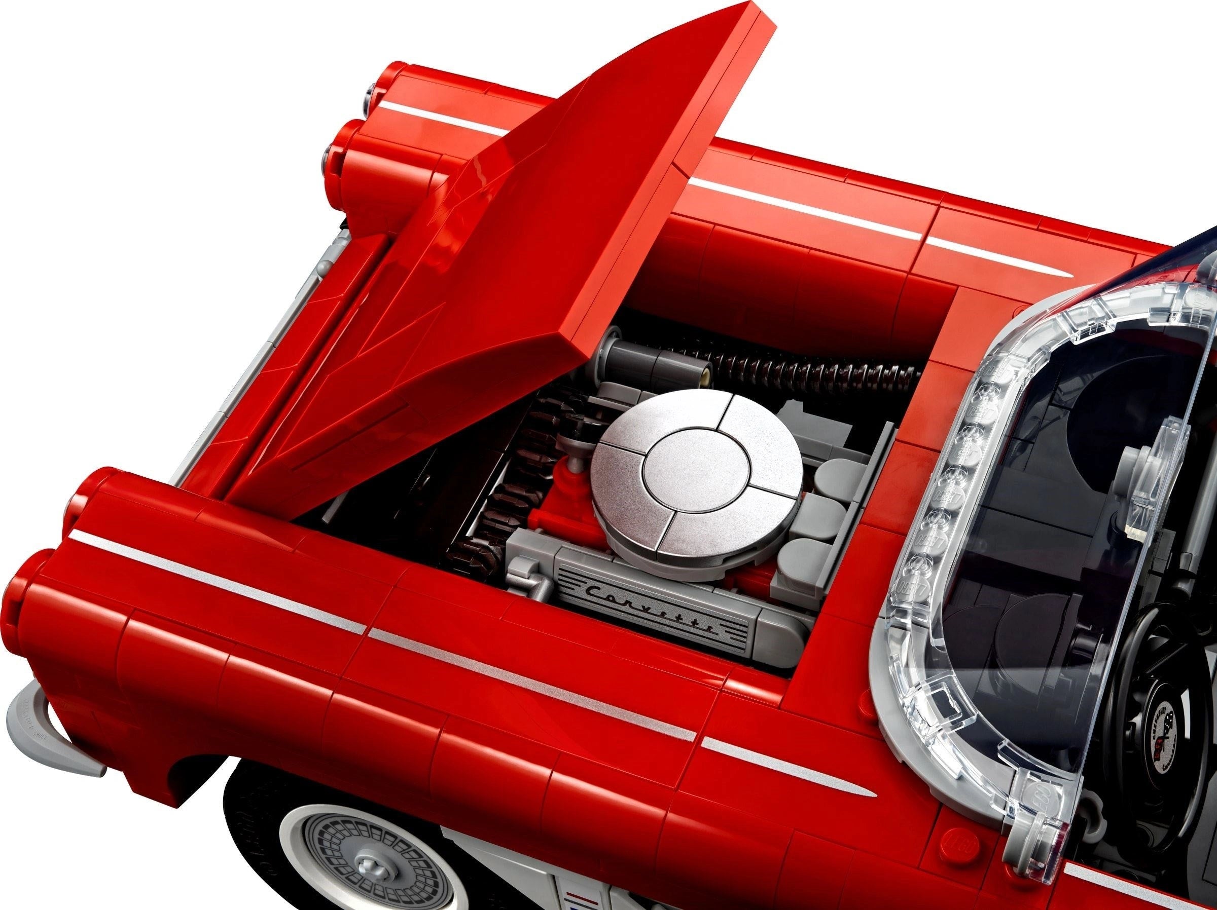 Close-up of a red car model with an open hood on a white background