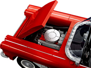 Close-up of a red car model with an open hood on a white background