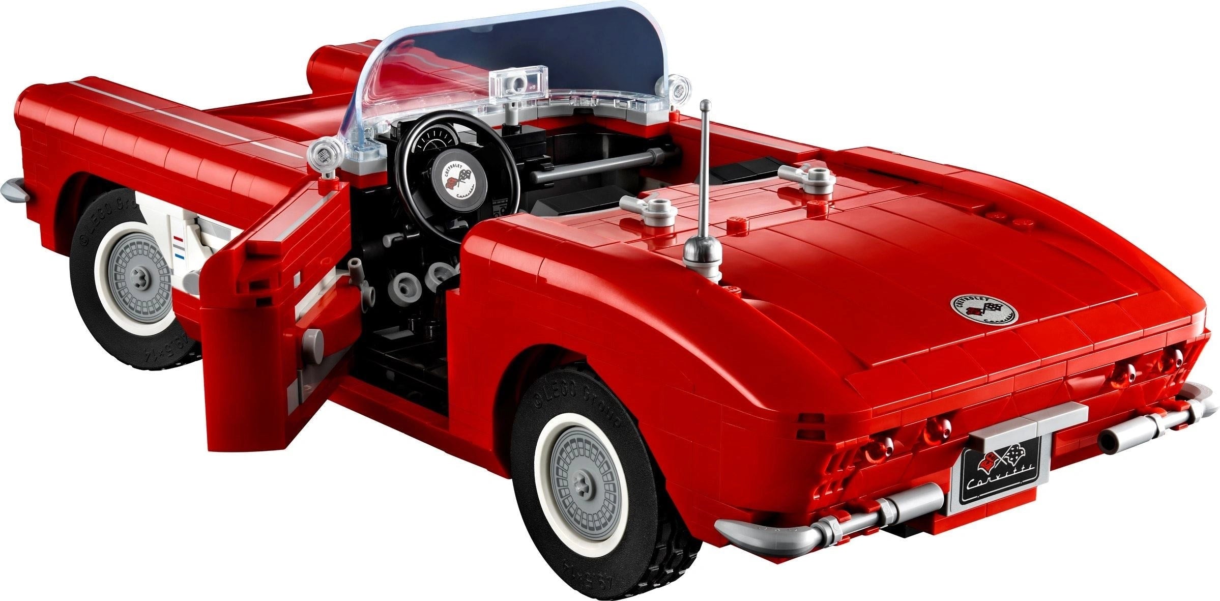 Red convertible car model made of interlocking bricks on a white background