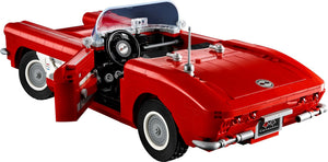 Red convertible car model made of interlocking bricks on a white background