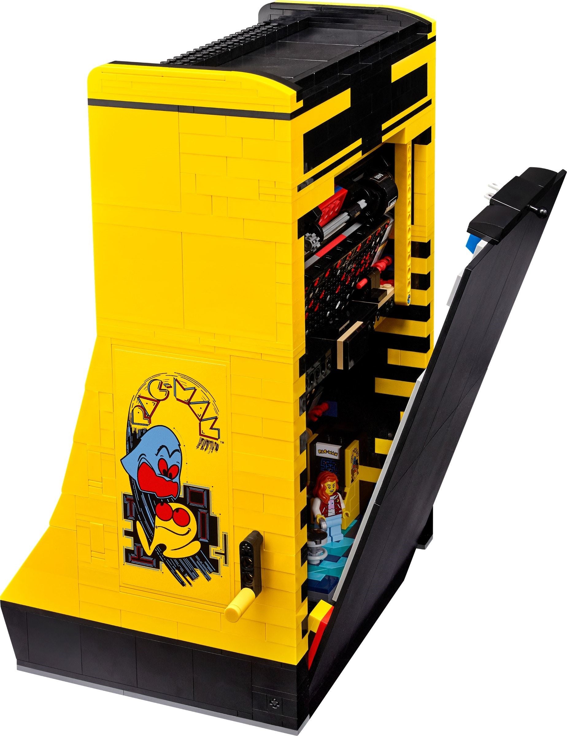 Yellow and black arcade machine model with open door showing toys inside on a white background