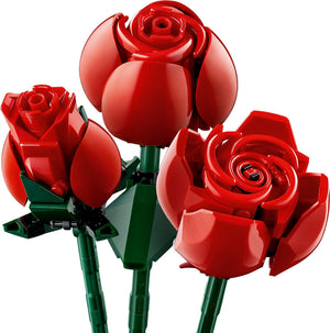 Three red roses made of interlocking bricks on a white background