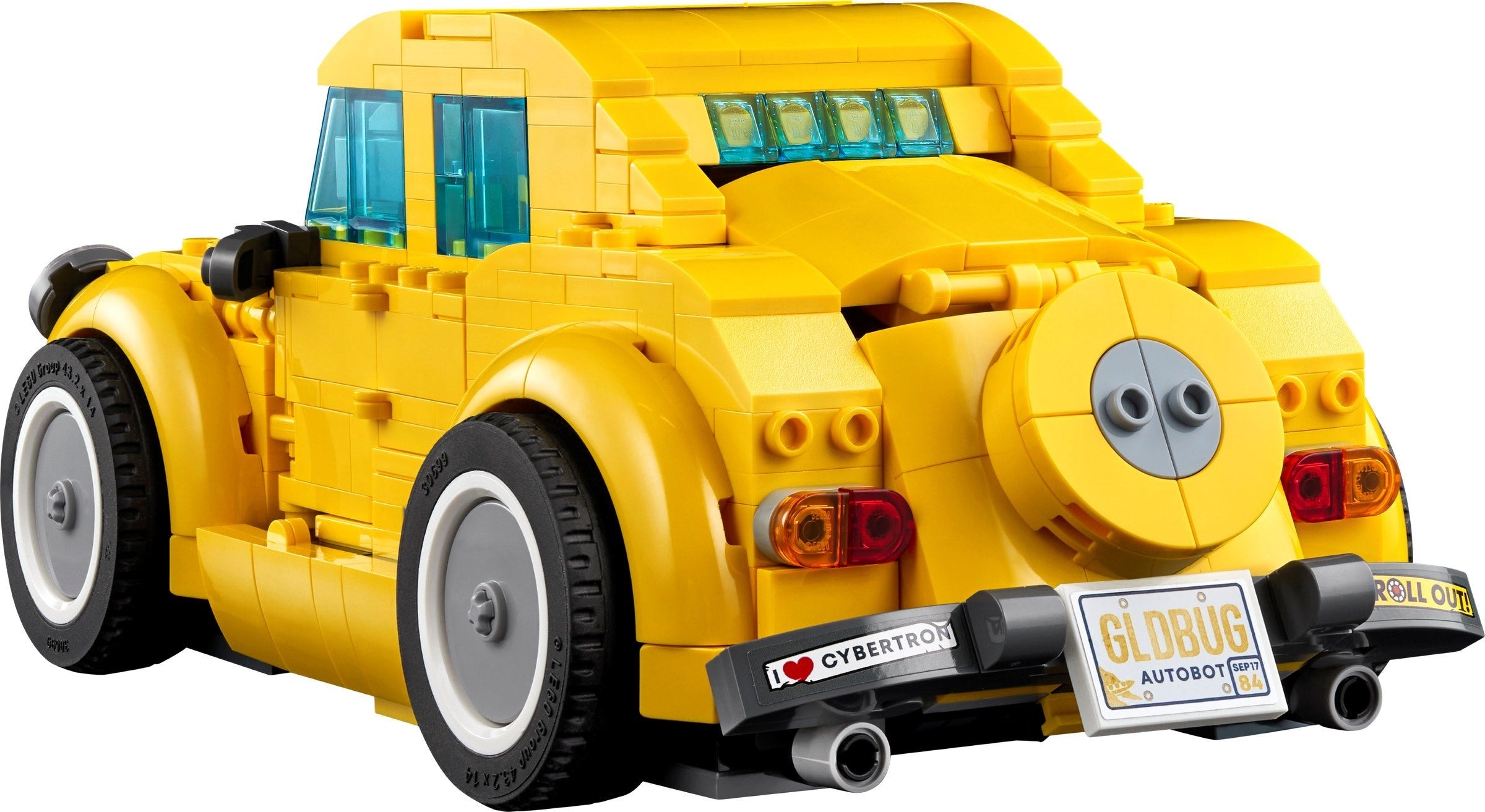 Yellow toy car model resembling a classic vehicle with visible branding on a white background
