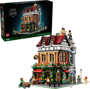 LEGO building set with detailed architecture and people figures, next to its packaging.