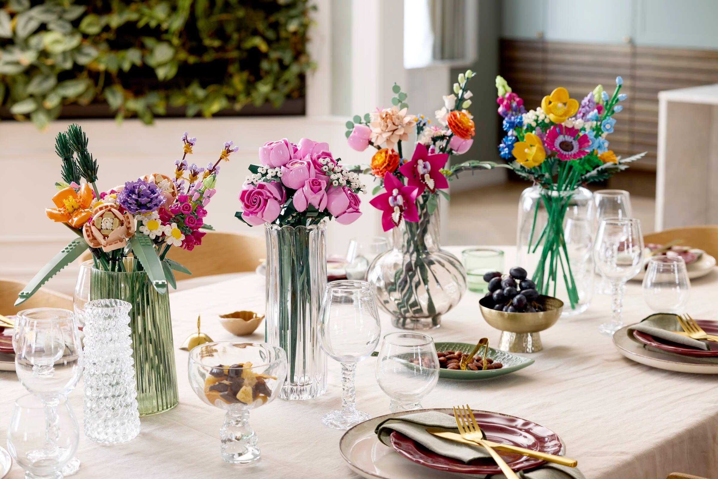 Decorative table setting with colorful flowers and tableware.