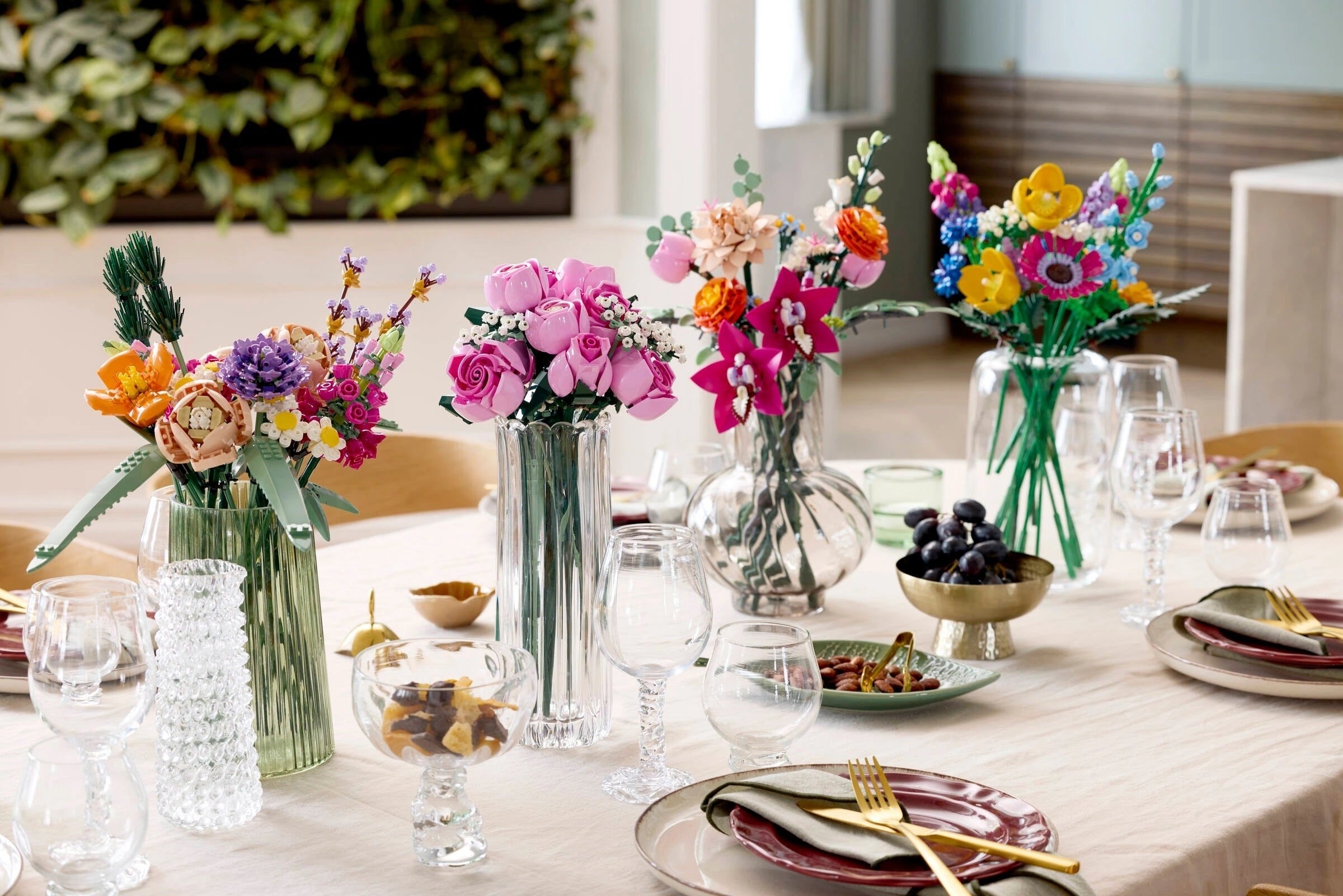Decorative table setting with colorful flower arrangements and tableware.